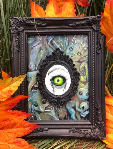 Monstrous sculpted clay eye with a background of fantasy characters.