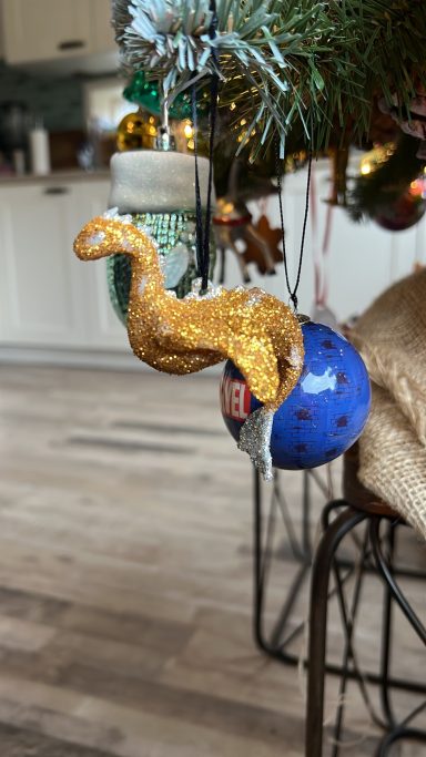 3D printed ornament of Loch Ness’s monster completely covered in gold colored glitter.